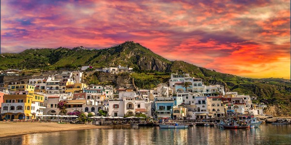 sunset on higgledy-piggledy piled houses on bay of Ischia island, Naples in Italy