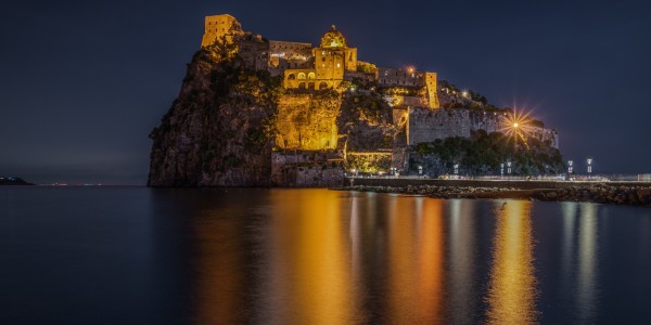 Night view of Aragonese Castle (Castello Aragonese), the most famous landmark of Ischia, Campania region, Italy